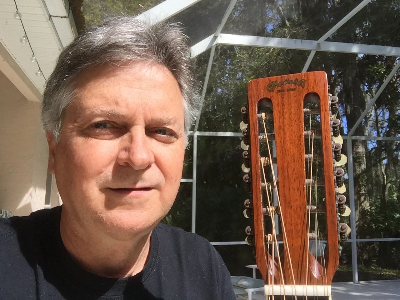 Guy Savino with harp in background